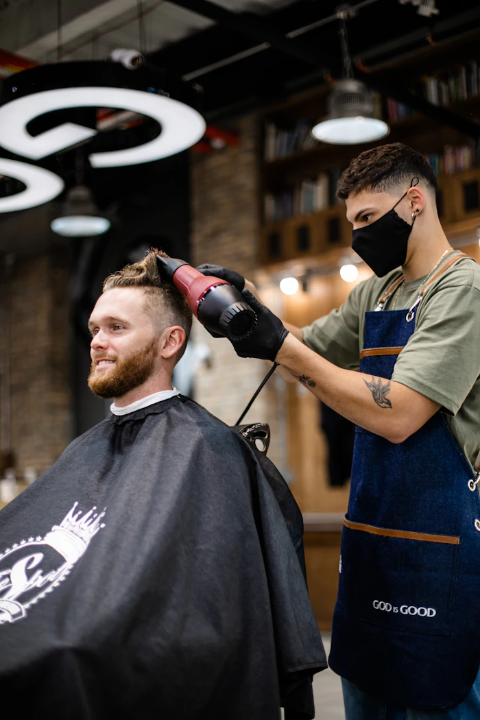 A barber at work with a client in the chair