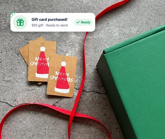 A customer hands over a gift card, with a 'Gift card purchased' notification