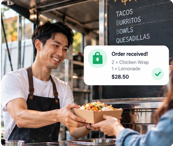 A food truck owner hands over an order, with an 'Order received' notification